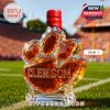 Close-up of the Clemson whiskey bottle labeled Style 1 with a red cap, featuring the university’s logo on a paw-shaped design.