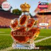 Close-up of the Clemson whiskey bottle labeled Style 3 with a crown-shaped cap and paw-shaped design.