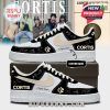 Detailed side view of Cortis custom sneakers with signature graphics, beige swoosh, and custom name space, placed on box with stylish group photo behind!