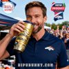Broncos fan sipping from a gold edition tumbler at a lively pre-game tailgate party!