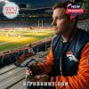 Person holding the Denver Broncos collectible bottle inside the stadium, wearing Broncos gear.