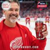 Hockey fan holding a red Detroit Red Wings YETI tumbler inside a crowded ice rink during a live game!