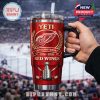 Close view of a Detroit Red Wings anniversary tumbler held up inside a packed hockey stadium!