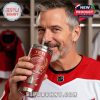 Red Wings fan drinking from a red YETI tumbler in a locker room environment filled with hockey equipment!
