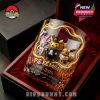 A detailed Pokémon 30th Anniversary whiskey glass sits in a red velvet-lined box, featuring Pikachu, Sylveon, and Eevee in party outfits!