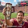 FSU fan poses with collectible tumbler among university memorabilia, highlighting the product’s emotional and nostalgic appeal!
