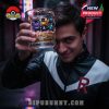 A man in a Team Rocket jacket holds up a glass with Gengar, Pikachu, and Lucario in a dark alley with neon lights!
