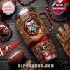 Georgia Bulldogs insulated tumbler with red and gold design, surrounded by themed football gear and decorative fan items!