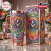 Grateful Dead thermal tumbler and box set with psychedelic rainbow designs and gem-inspired decorations, placed on a table with soft lighting and flowers!
