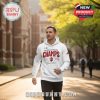 Man wearing white Indiana champs hoodie walking on a campus path!