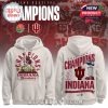 A white hoodie with a two-sided design: the front shows a detailed graphic of the Indiana Hoosiers mascot and stadium, and the back highlights the words Rose Bowl Champions 2026 Indiana with a trophy image.