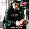 Man wearing black Hoosiers football hoodie sitting in a locker room with a football!