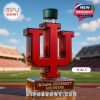 Red university logo perfume bottle standing on a field with stadium seats in the background!