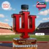 Red university symbol perfume bottle with dark cap placed on sports field!