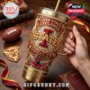 Hand-held view of Iowa State tumbler with vibrant college graphics and football-themed background.