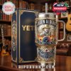 Elegant Jason Aldean tour tumbler beside gold-embossed box in a home library with guitars in background.