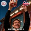 A fan celebrates with a Liverpool themed whiskey glass outside the football ground!