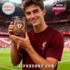 A smiling fan displays a Liverpool whiskey glass during a match day moment!