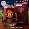 Manchester United 148th anniversary Style 4 glass on a wooden surface, filled with ice, and accompanied by an ornate collector’s box under stadium lighting.