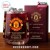 Product-only shot of the 148th Anniversary Manchester United whiskey glass and maroon box, highlighting every etched detail and gold accent.