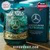 Turquoise whiskey glass with gold etched F1 racing design and Mercedes AMG PETRONAS branding beside a custom gift box in a motorsport environment!