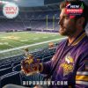Fan holding the Minnesota Vikings Limited Edition Whiskey Bottle in the stadium, with the Viking logo and anniversary marking clearly visible.