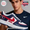 Person holding navy red and white Ole Miss championship sneakers with visible team graphics!