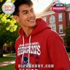 A young man smiling in a red hoodie with a sports design against a green outdoor campus backdrop, showcasing the Allstate Sugar Bowl Champions 2026.
