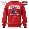 A red Ole Miss Sugar Bowl 2026 crewneck sweater with a bold CHAMPIONS print, navy helmet graphic, and location details for New Orleans, Louisiana!