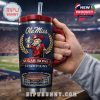 Man in hoodie holding Ole Miss tumbler in sports memorabilia room.