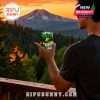 Man holding Oregon Ducks glass outdoors at sunset with mountain view