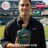 A man proudly holding the Philadelphia Eagles 92nd Anniversary Whiskey Bottle in front of the football stadium.