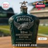 Man holding the Philadelphia Eagles 92nd Anniversary Whiskey Bottle in the stadium seating area.