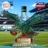 Eagle shaped glass bottle with green cap displayed on a football field background!