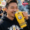 A man drinking from a Steelers-themed Stanley tumbler with Terrible Towel graphics, wearing a black hoodie at an outdoor gathering.