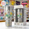 A metal Pokemon tumbler with a handle and straw is displayed with a commemorative box in front of a wall filled with Pokemon artwork!