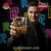 A man displays a 30th Anniversary Pokémon collectible glass, showing off its character miniatures and vivid flame-like design against a neon backdrop!