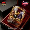 A limited-edition 30th Anniversary Pokémon glass rests in a red velvet box, detailed with three iconic characters and lightning visuals!