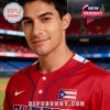Red baseball jersey with Puerto Rican flag and blue piping details worn by a player standing in a sports stadium!