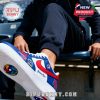 Close-up of custom Puerto Rico 2026 sneakers worn at a stadium with visible logos and personalization.