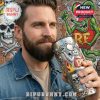 Man holding a silver Rat Fink tumbler with skull and flame design in an urban street art setting!
