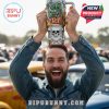 Man holding Rat Fink tumbler overhead at an outdoor car event with crowd and vehicles!