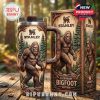 Stanley Bigfoot tumbler with matching box on wooden table, both showing carved Bigfoot and forest designs!