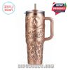 Rose gold tumbler with a cowboy hat, flowers, and the name 
