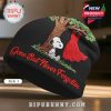 Black beanie with Snoopy under a tree next to a red dress. Text: Gone But Never Forgotten.!