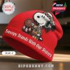 Red beanie with Snoopy in native american attire holding a dream catcher. Text: Snoopy Stands With Our Sisters.!
