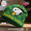 Snoopy wearing a shamrock hat for St. Patrick's Day on a green beanie.