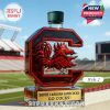 Letter C shaped red glass whiskey bottle with rooster emblem displayed on a football field!