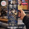 Close-up of a hand holding a Star Trek tumbler with classic characters on screen and Star Trek memorabilia in the background.