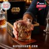 Hand offering a detailed gold-etched Star Wars glass in front of a premium gift box, bar tools and decanter nearby, creating a festive and luxurious gifting moment!